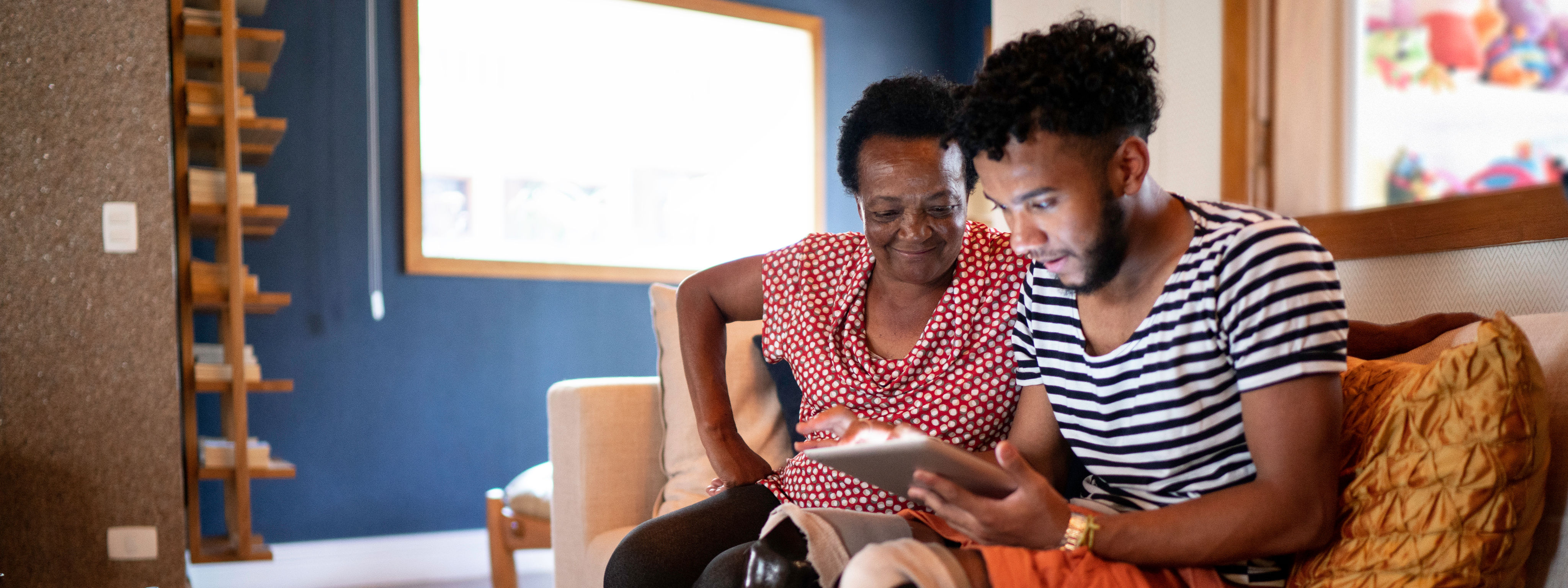 Mother watching son on tablet